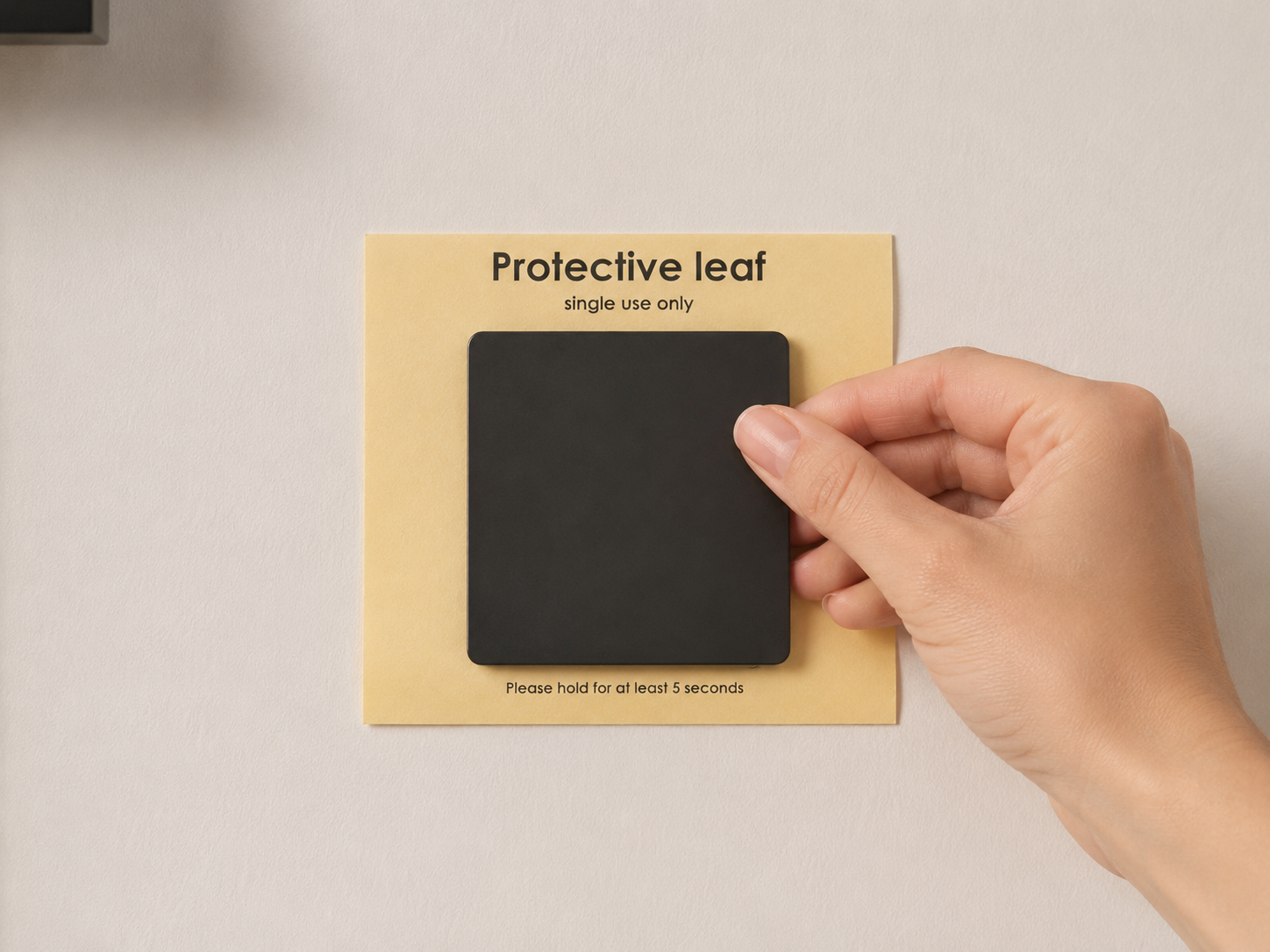 Step 2 &mdash; Apply the self-adhesive protective leaf holding the magnet